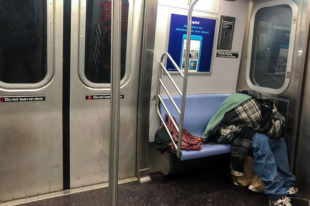 A person sleeps on the subway.